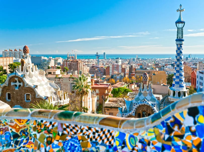 Gaudí's mosaic terrace and curved architecture at Park Güell in Barcelona